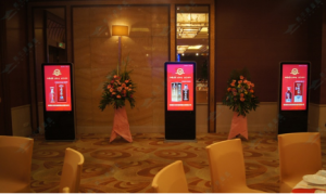 What are the benefits of deploying LCD advertising machines and touch all-in-one machines in hotels?